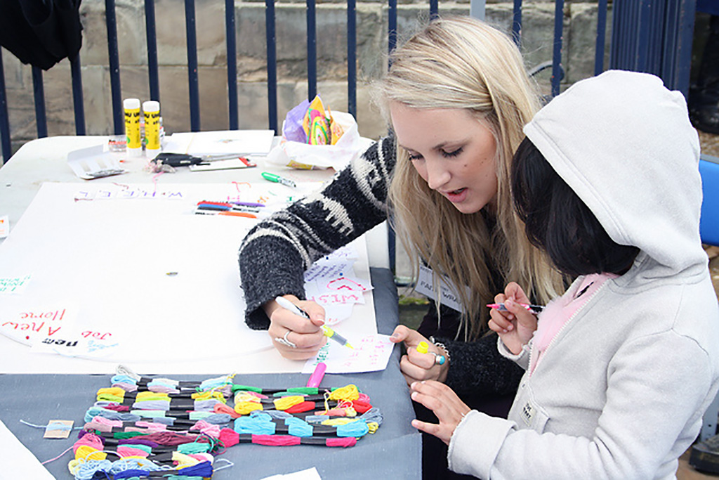 The mother is painting with her daughter.