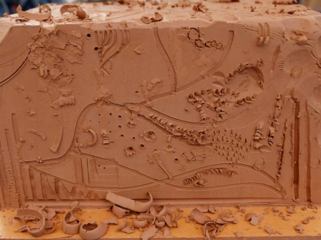 A big clay block on which participants carved various patterns.