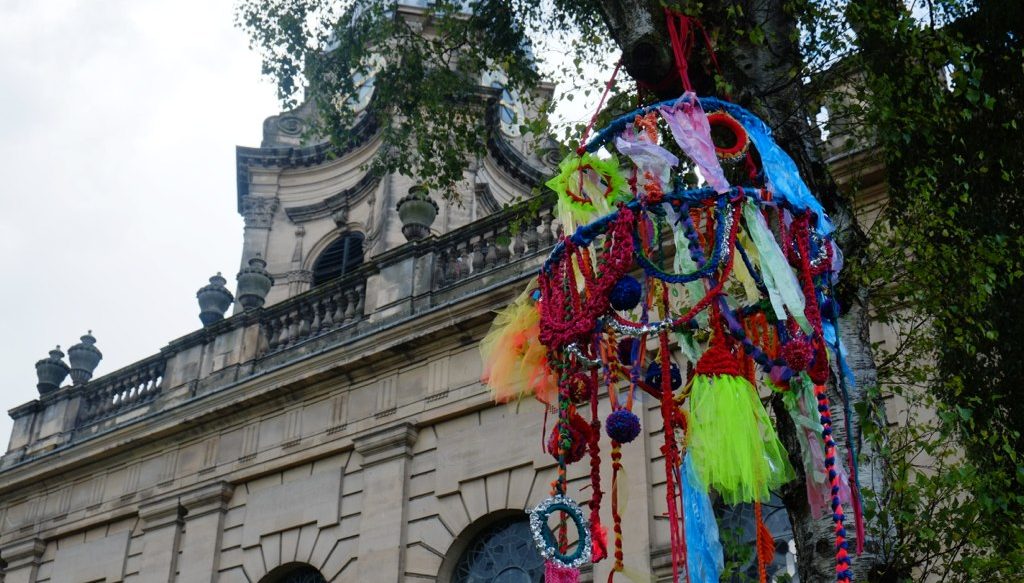 the large-scale brightly coloured chandelier was hung up in the tree in front of the Cathedral