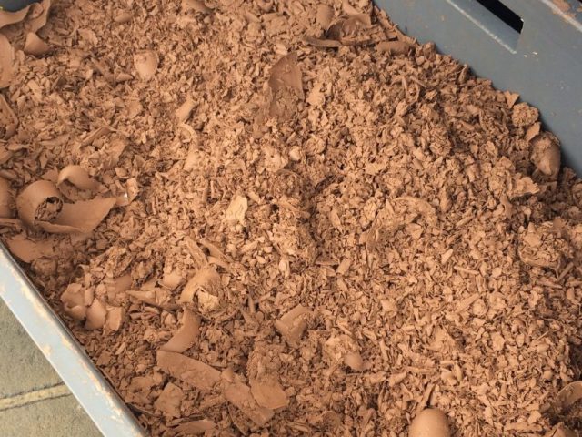 A large bucket of clay scrap remains.