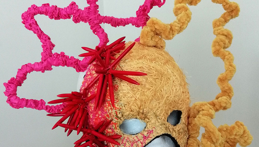 sculptural face mask in pink and yellow fabric
