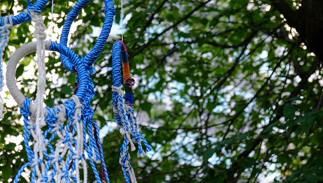 knotted macrame hoops hanging in tree