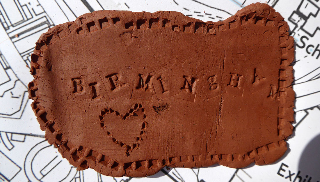 BIRMINGHAM and a heart stamped in clay