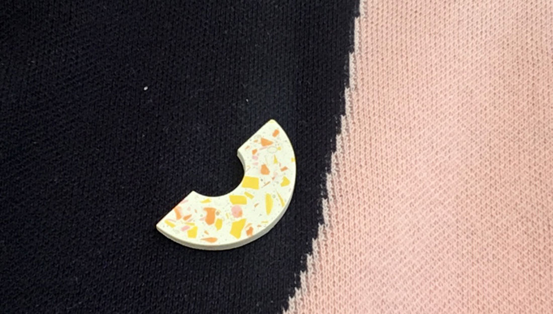 semi circle shaped jesmonite brooch on a jumper